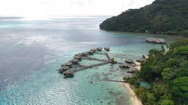 Luxury Resort in French Polynesia. Drone Shot of Overwater Bungalows, Beach and Island's Coastline