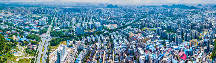 Aerial Panorama of Dense Asian City with Residential Complexes and Mountains