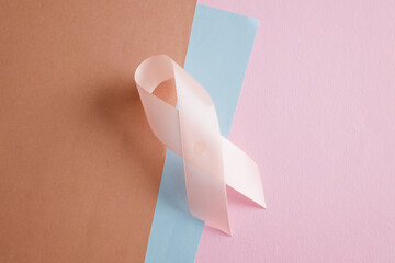 Pink ribbon symbolizing breast cancer awareness, hope and support concept.