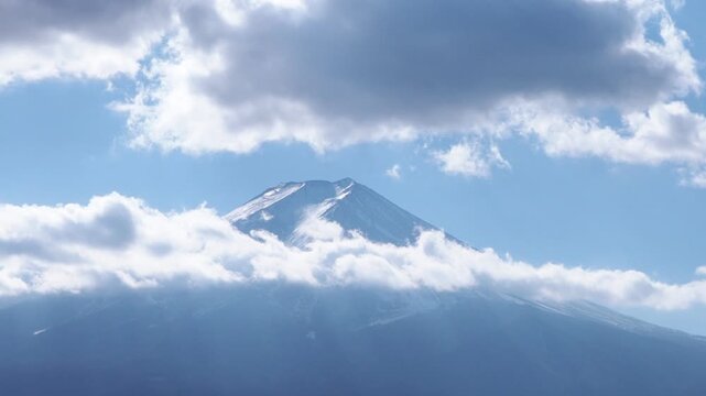 A landscape view of Mount Fuji amidst the drifting clouds.