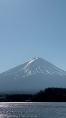 A vertical photograph of Mount Fuji and a lake in Japan.