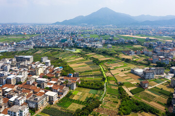 Aerial Countryside and Farmland Surrounding Modern Asian City with Mountain © NguyenNgoc