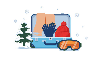 Flat lay of a blue suitcase packed with winter clothing and gear, including a scarf, gloves, hat, and goggles, next to a small Christmas tree on a snowy white background, evoking a sense of © Anton