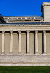 Fototapeta premium Columns and wall of an old building as an abstract background, architectural details
