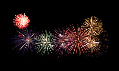 Festive colorful fireworks display isolated on black background for celebration and anniversary