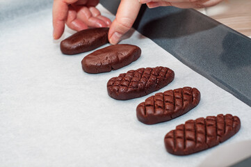 Making chocolate cookies on a baking sheet with parchment paper