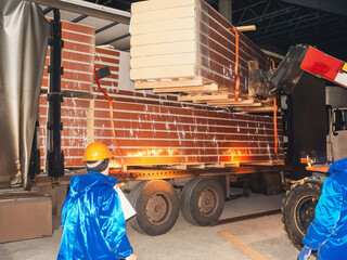 Forklift loading insulated panels onto a truck for delivery at a warehouse