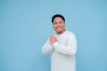 a young asian man raises his thumb with happy facial expression for his success 