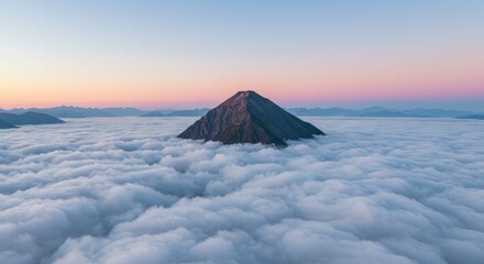 Mountain peak rising above a sea of clouds at dawn