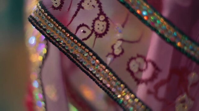 Macro of sari silk threads moving on a loom, shimmering fibers catching light, gold embroidery glinting, hyper detail, rhythmic and graceful.