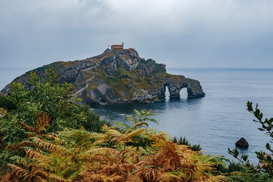 San Juan de Gaztelugatxe Islet with Natural Stone Arch and Ferns, Spain