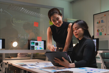 Businesswomen collaborating on market data analysis in office