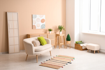 Fototapeta premium Interior of light living room with sofa near beige wall