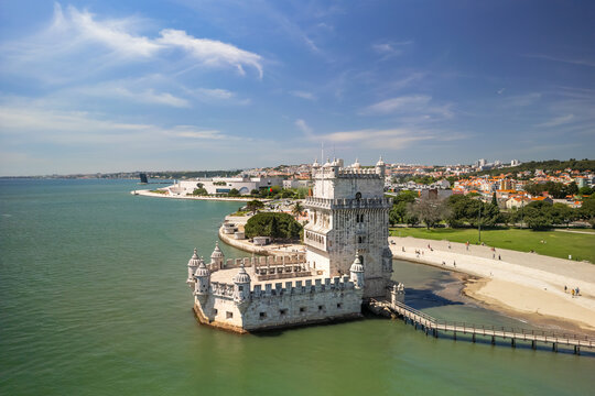 Aerial view of Belem tower and wooden pier during sunny day near Lisbon, Portugal, landmark of the city. UNESCO World Heritage Site.