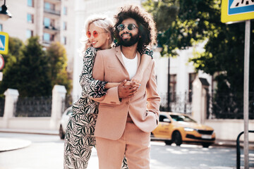 Beautiful fashion woman and her handsome elegant boyfriend in beige suit. Sexy blond model in...
