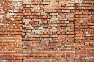 Fototapeta premium Old weathered brick wall texture background for industrial design or grunge backdrop. Rough surface with cracked and peeling paint showing age concept.
