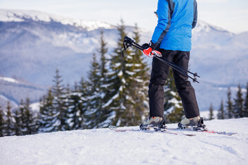 Skier at mountain viewpoint on snowy slope at winter resort
