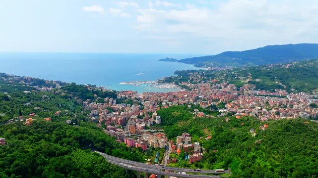 Panoramic drone shot circling the Rapallo town and the sea of the Italian Riviera