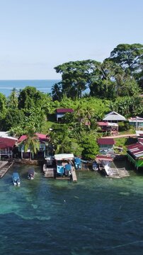 Scenic vertical aerial shot moving right over Bastimentos Island, highlighting the natural beauty of the Bocas del Toro region.