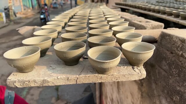 In a sunlit village of Bengal, artisans lay out terracotta kulhads to bake under the open sky.