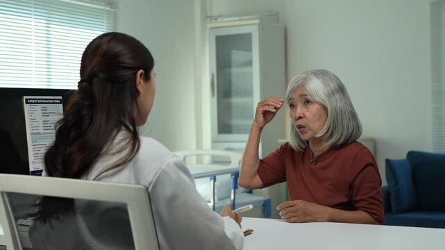Elderly patient describing headache symptoms to doctor