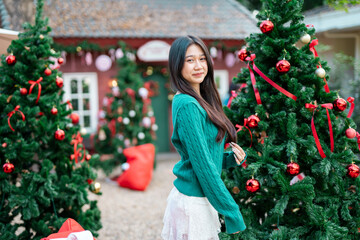 During Christmas time, a happy young woman enjoys a large Christmas gift.