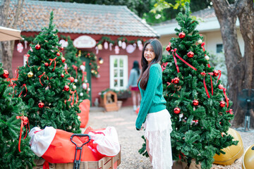 During Christmas time, a happy young woman enjoys a large Christmas gift.