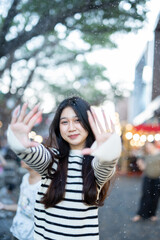 Beautiful young woman spinning in the winter snow 