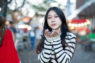 Beautiful young woman spinning in the winter snow 