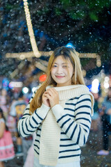 Beautiful young woman spinning in the winter snow 