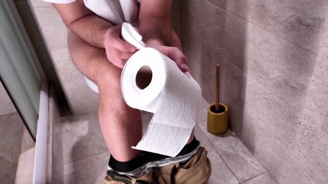 Man with urge to go to the toilet at home.