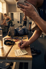 Sweaty Athlete Writing Post-Workout Routine on Sticky Note in Locker Room
