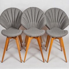 Three grey upholstered chairs, wooden legs, radial design