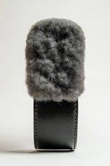 Gray fur microphone wind muff on a black square stand