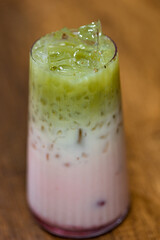 Layered Berry Milk Drink With Ice In Tall Glass On Wooden Table, Refreshing Summer Beverage



