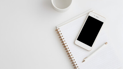 Digital Workspace: A sleek modern desk setup featuring a smartphone, a blank notepad, a pencil, and a mug, minimalist design with a clean aesthetic, ideal for productivity and creative work.
