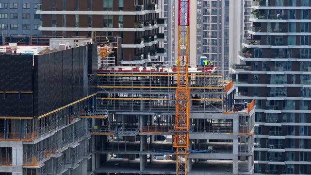 Aerial drone view of construction workers on a high rise building in the Belgrade Waterfront district