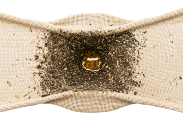 Filtering tea liquid through rustic burlap fabric mesh on a transparent background