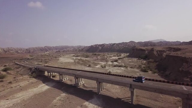 Ariel shot Bus Crossing Bridge on Makran Coastal Highway, Balochistan, Pakistan &ndash; Cinematic Aerial Drone Footage