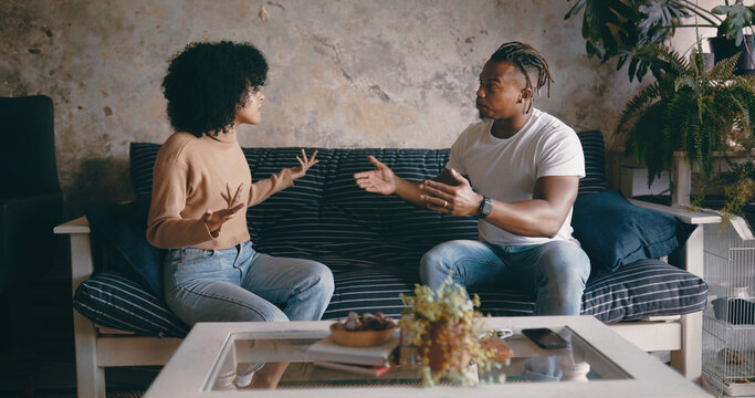 Home, angry and couple on sofa, argument and fighting with toxic relationship, divorce and cheating. Conflict, man and black woman with breakup, talking or frustrated with disagreement and unhappy