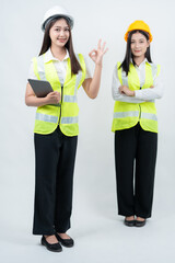 Vertical photo of Asian female engineers discussing project updates, reflecting AI-based decision making, smart industry practices, collaborative teamwork, and professional safety culture.