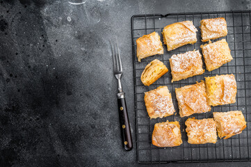 Milk pie custard pastry made of crispy filo layers sliced and served as bakery dessert with copy space