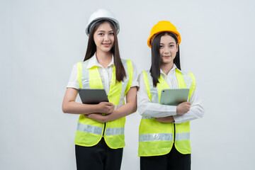 A team of Asian female engineers uses tablets for construction planning, professional teamwork, and strategic business development that supports the company's long-term success.