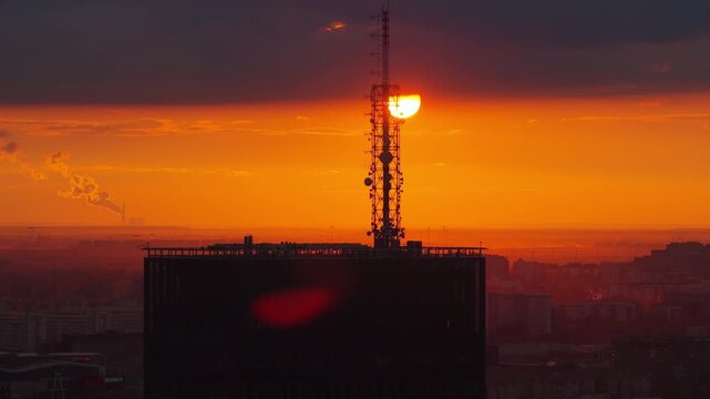 Aerial drone view of the telecommunication antennas on top of Usce Tower during a warm golden sunset in Belgrade, Serbia