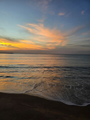 Serene sunset over Baan Krood Beach, Thailand, paints the sky in vibrant hues