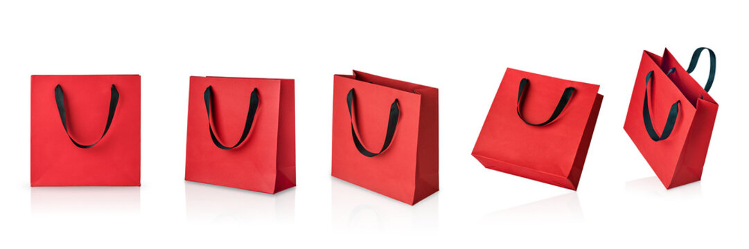 Set of red paper gift bags with black handles isolated on white background with clipping path. Design element. Holiday Sale Concept.