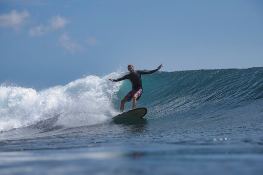 Surfer Trimming Along Clean Green Wave