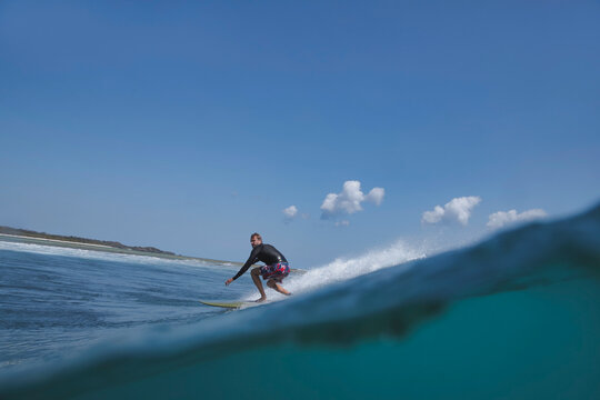 Surfer Carving On Open Wave Face,Split shot