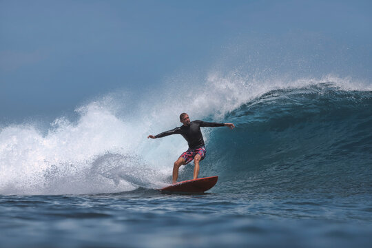 Surfer rides a powerful wave