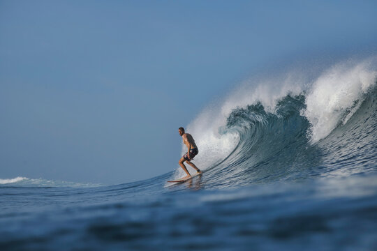 Surfer on a blue wave